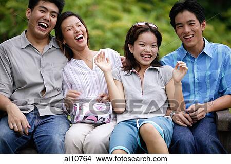 Group of friends, sitting side by side, laughing View Large Photo Image Picture - Group of friends, sitting side by side, laughing. Fotosearch