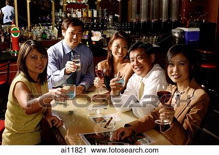 Group of people raising wine glasses, looking at camera View Large Photo Image Stock Image - Group of people raising wine glasses, looking at camera. Fotosearch