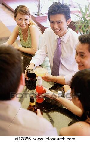 Group of young adults talking at bar ( high angle view) View Large Photo Image Stock Photograph - Group of young adults talking at bar ( high angle view). Fotosearch