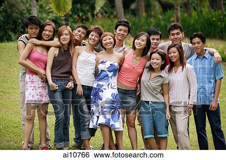 Group of young people posing at park. View Large Photo Image Stock Photograph - Group of young people posing at park.. Fotosearch
