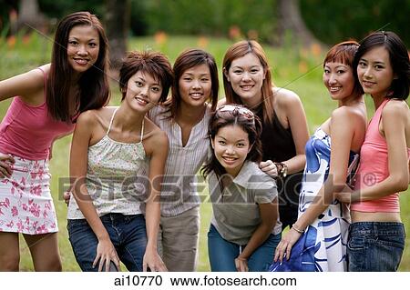 Group of young women posing for camera View Large Photo Image Stock Image - Group of young women posing for camera. Fotosearch