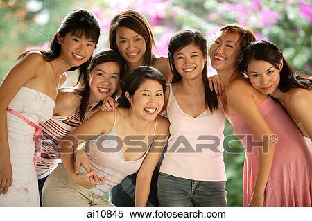 Group of young women, posing for camera, smiling View Large Photo Image Stock Photography - Group of young women, posing for camera, smiling. Fotosearch