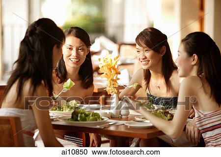 Group of young women, sitting down at cafe, talking View Large Photo Image Stock Image - Group of young women, sitting down at cafe, talking. Fotosearch