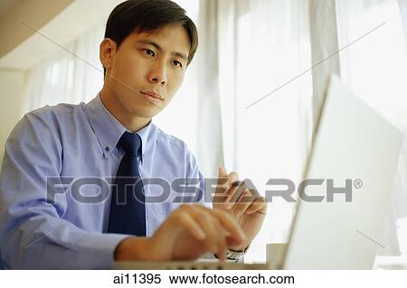 Male executive using laptop View Large Photo Image Stock Photography - Male executive using laptop. Fotosearch