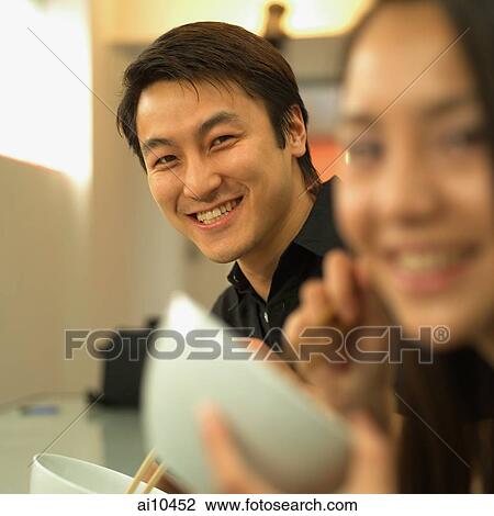 Man and woman looking at camera, smiling View Large Photo Image Stock Image - Man and woman looking at camera, smiling. Fotosearch