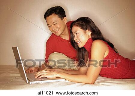 Man and woman side by side, using laptop View Large Photo Image Stock Image - Man and woman side by side, using laptop. Fotosearch