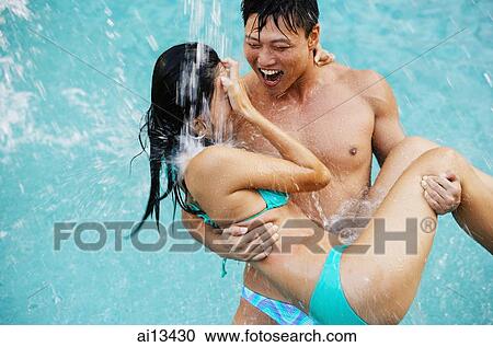 Man carrying woman in bikini View Large Photo Image Stock Image - Man carrying woman in bikini. Fotosearch