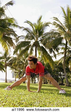 Man doing stretching exercises in park, bending forward View Large Photo Image Stock Photograph - Man doing stretching exercises in park, bending forward. Fotosearch