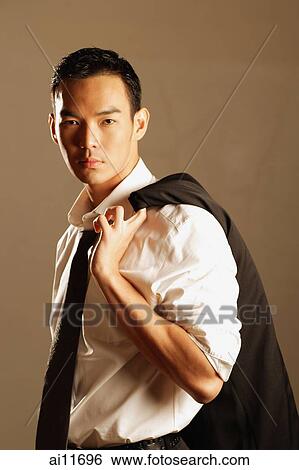 Man dressed in shirt and tie with jacket slung over shoulder View Large Photo Image Stock Photograph - Man dressed in shirt and tie with jacket slung over shoulder. Fotosearch