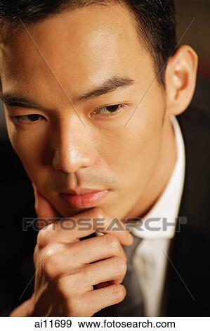 Man dressed in suit, hand on chin, portrait View Large Photo Image Stock Photo - Man dressed in suit, hand on chin, portrait. Fotosearch