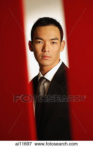 Man dressed in suit, looking at camera View Large Photo Image Stock Photo - Man dressed in suit, looking at camera. Fotosearch