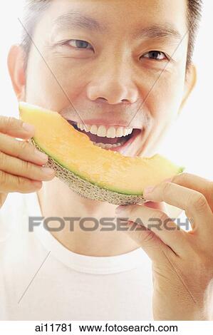 Man eating melon, smiling View Large Photo Image Stock Image - Man eating melon, smiling. Fotosearch