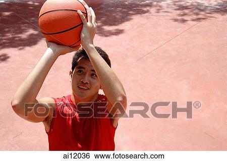 Man holding basketball, aiming View Large Photo Image Stock Photograph - Man holding basketball, aiming. Fotosearch