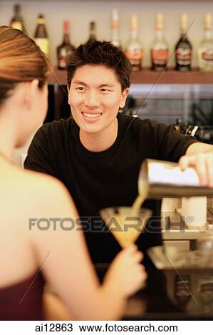 Man holding cocktail mixer, pouring drink for woman View Large Photo Image Stock Image - Man holding cocktail mixer, pouring drink for woman. Fotosearch