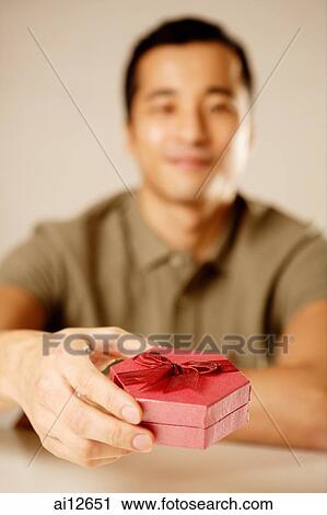 Man holding gift box View Large Photo Image Stock Image - Man holding gift box. Fotosearch