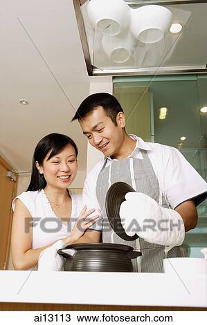 Man holding lid of pot, wife next to him View Large Photo Image Stock Image - Man holding lid of pot, wife next to him. Fotosearch
