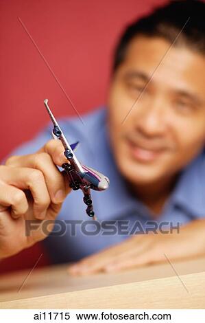 Man holding model airplane, focus on the foreground View Large Photo Image Stock Photography - Man holding model airplane, focus on the foreground. Fotosearch