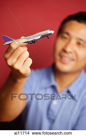 Man holding model airplane View Large Photo Image Picture - Man holding model airplane. Fotosearch