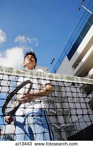 Stock Image - Man holding tennis racket. Fotosearch