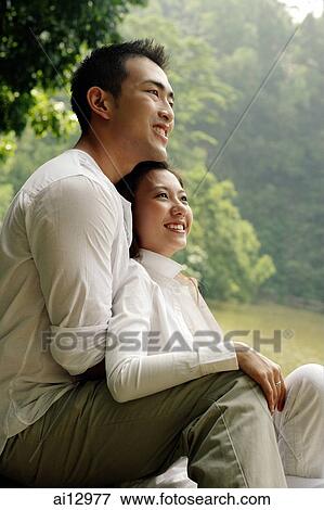 Man hugging woman from behind View Large Photo Image Stock Photo - Man hugging woman from behind. Fotosearch