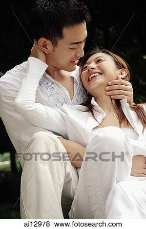 Man hugging woman, woman looking up at him View Large Photo Image Stock Photo - Man hugging woman, woman looking up at him. Fotosearch