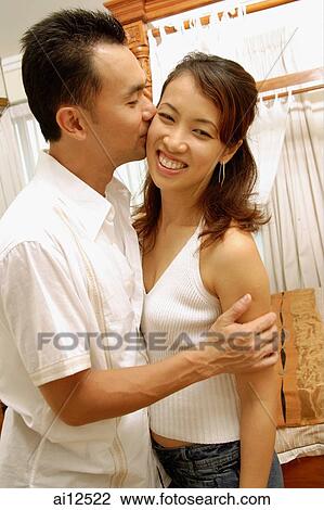 Man kissing woman on cheek View Large Photo Image Stock Image - Man kissing woman on cheek. Fotosearch