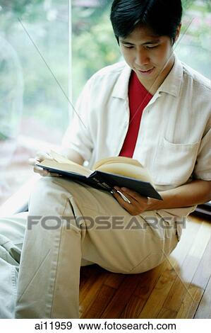 Man leaning on window, reading a book View Large Photo Image Stock Photo - Man leaning on window, reading a book. Fotosearch