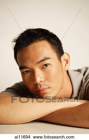 Man looking at camera, head resting on arm View Large Photo Image Picture - Man looking at camera, head resting on arm. Fotosearch