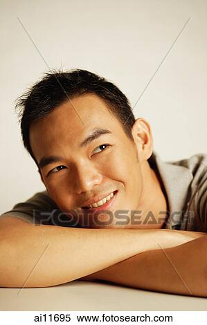 Man looking away, smiling, head resting on arm View Large Photo Image Stock Photography - Man looking away, smiling, head resting on arm. Fotosearch