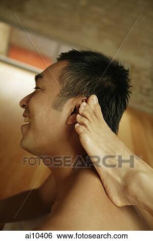 Man looking away, woman's foot on his shoulder View Large Photo Image Stock Photograph - Man looking away, woman's foot on his shoulder. Fotosearch