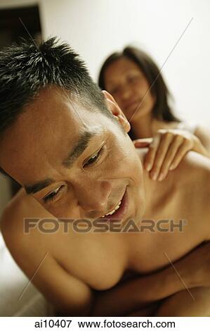 Man looking down, woman's hand on his shoulder View Large Photo Image Stock Photo - Man looking down, woman's hand on his shoulder. Fotosearch