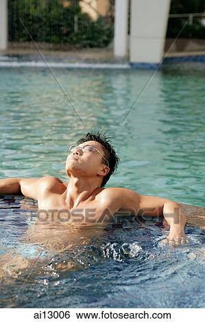 Man lounging in pool, looking up View Large Photo Image Stock Photograph - Man lounging in pool, looking up. Fotosearch