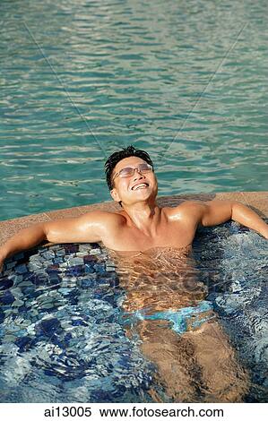 Man lounging in pool, smiling View Large Photo Image Stock Photography - Man lounging in pool, smiling. Fotosearch