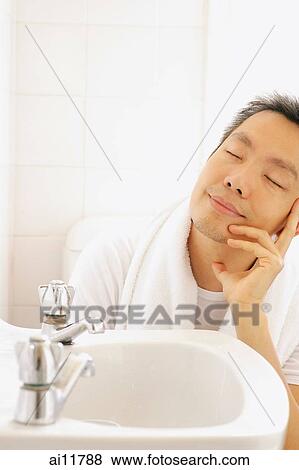 Man on toilet, hand on chin, eyes closed View Large Photo Image Stock Photo - Man on toilet, hand on chin, eyes closed. Fotosearch