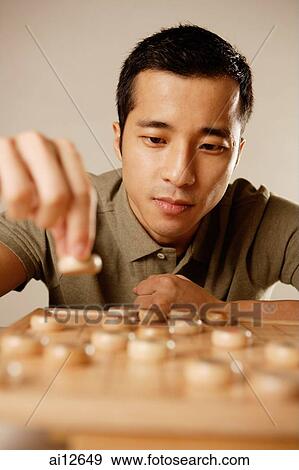 Man playing Chinese chess, concentrating View Large Photo Image Stock Photo - Man playing Chinese chess, concentrating. Fotosearch