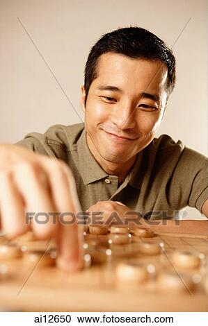 Man playing Chinese chess, smiling View Large Photo Image Stock Image - Man playing Chinese chess, smiling. Fotosearch