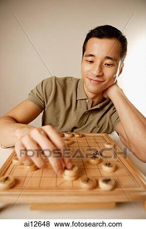 Man playing Chinese chess, smiling View Large Photo Image Stock Photo - Man playing Chinese chess, smiling. Fotosearch