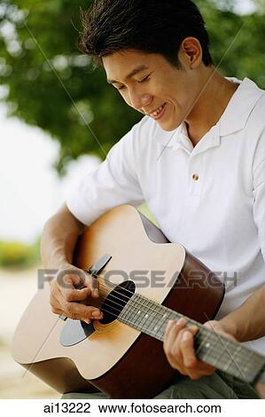 Man playing with guitar, portrait View Large Photo Image Stock Image - Man playing with guitar, portrait. Fotosearch