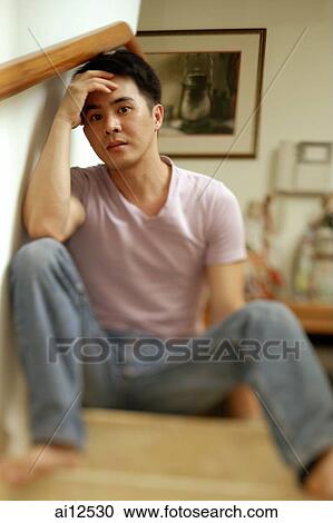 Man sitting on staircase, hand on head View Large Photo Image Stock Image - Man sitting on staircase, hand on head. Fotosearch