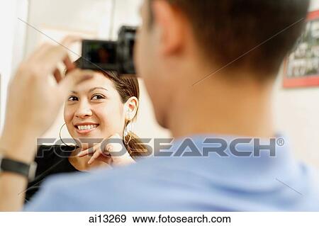 Man taking picture of young woman View Large Photo Image Stock Photo - Man taking picture of young woman. Fotosearch