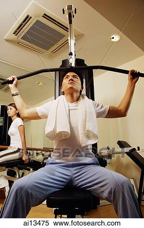 Man using exercise machine, low angle view View Large Photo Image Stock Photography - Man using exercise machine, low angle view. Fotosearch