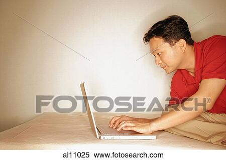 Man using laptop, sideview View Large Photo Image Stock Photography - Man using laptop, sideview. Fotosearch
