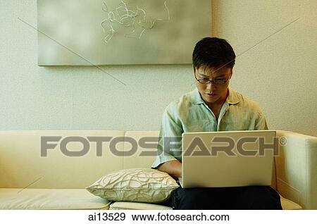 Man using laptop View Large Photo Image Stock Photo - Man using laptop. Fotosearch