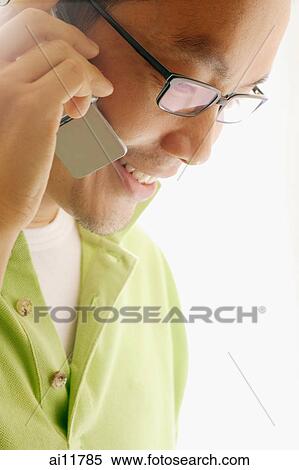 Man using mobile phone, sideview View Large Photo Image Stock Photography - Man using mobile phone, sideview. Fotosearch