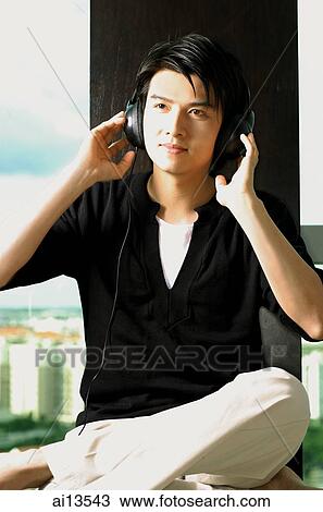 Man wearing headphones, listening to music View Large Photo Image Stock Image - Man wearing headphones, listening to music. Fotosearch