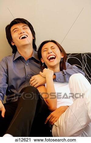 Man with arm around woman, laughing View Large Photo Image Stock Image - Man with arm around woman, laughing. Fotosearch