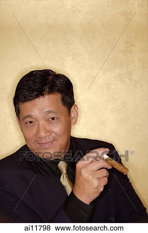 Stock Photo - Man with cigar looking at camera. Fotosearch