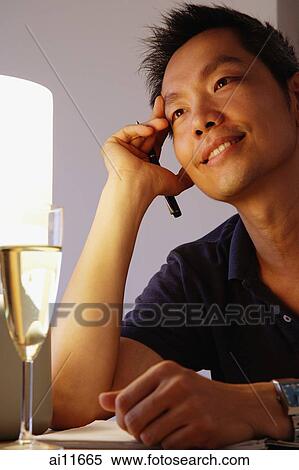 Stock Photography - Man with hand on head, looking away. Fotosearch