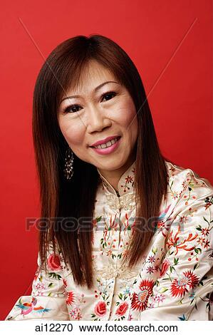 Stock Image - Mature woman looking at camera, portrait. Fotosearch