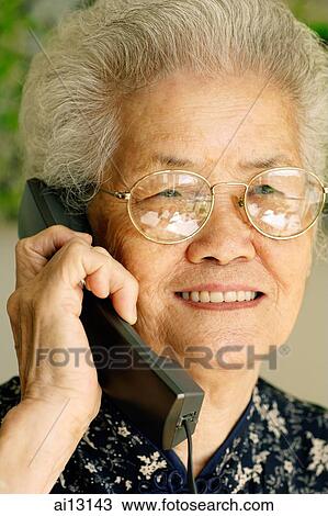 Mature woman using phone View Large Photo Image Stock Image - Mature woman using phone. Fotosearch